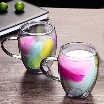 double-walled glass cup with some decorative feather