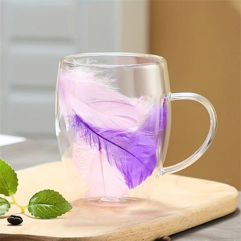 double-walled glass cup with some decorative feather